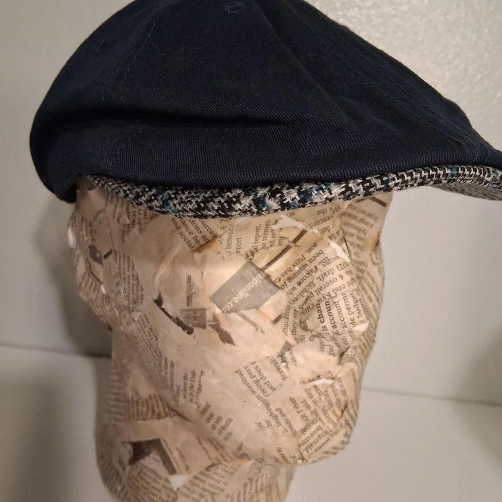 Mens Navy blue flat cap with white penguin logo plaid detail under brim